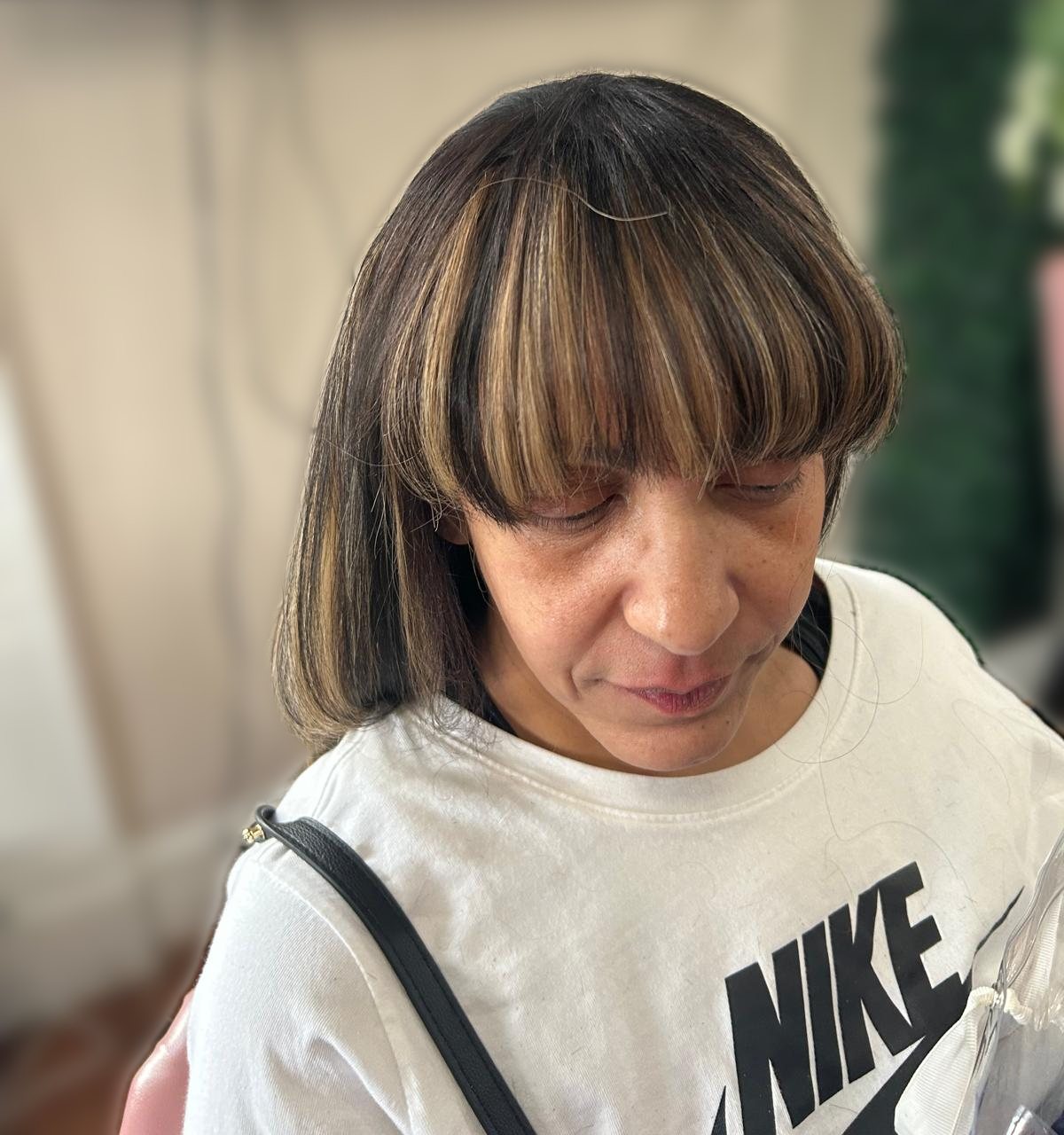 Blunt fringe with caramel highlights on dark hair