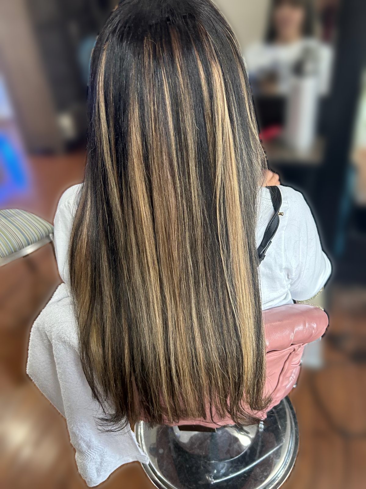 Long straight dark hair with bold golden highlights